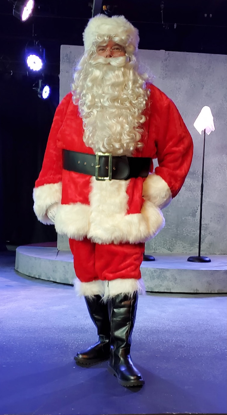 Santa Suscheck standing on stage at Lebanon Theatre Company
